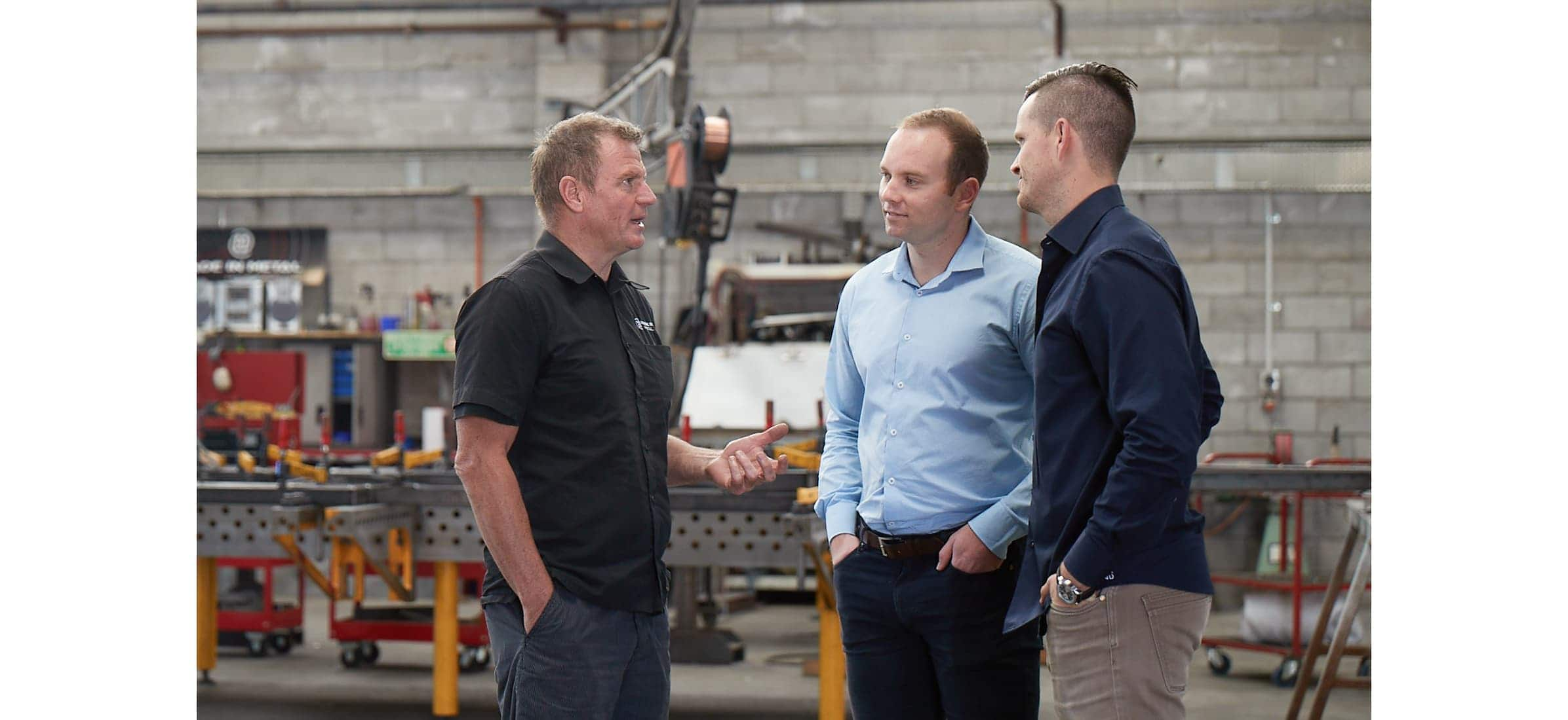 Ken from Made In Metal in the workshop talking to Nathan and Peter from Maisey Harris & Co.